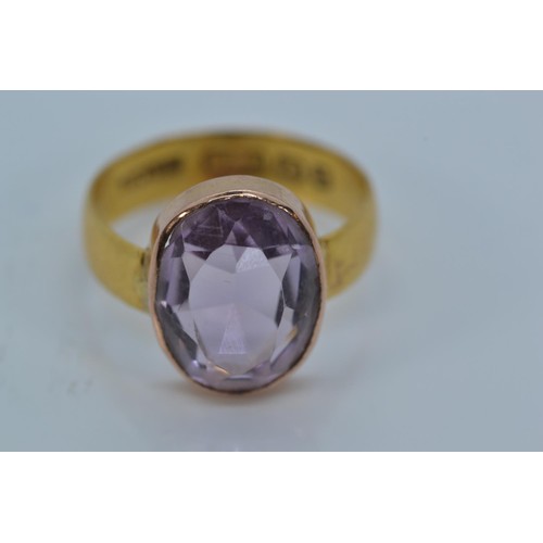 168 - 22ct gold band set with an oval-cut amethyst on yellow metal mount, size K, gross weight 3.22 grams