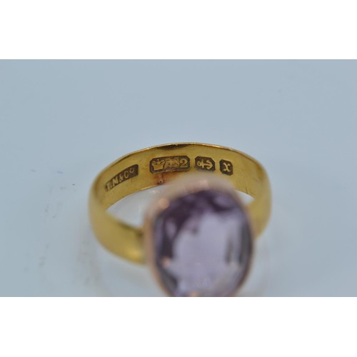 168 - 22ct gold band set with an oval-cut amethyst on yellow metal mount, size K, gross weight 3.22 grams