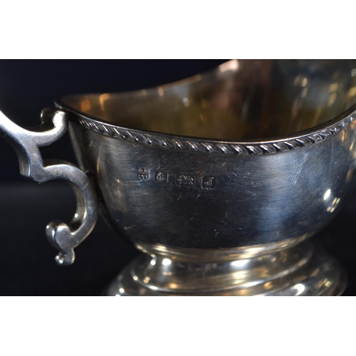 370 - Silver sauce boat, William Neale & Son, Birmingham 1933, with scroll handle, length 15cm, togeth... 