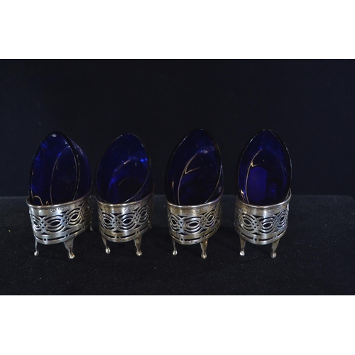 413 - Set of four silver pierced navette-shaped salts, William Aitken, Birmingham 1903, with blue glass li... 