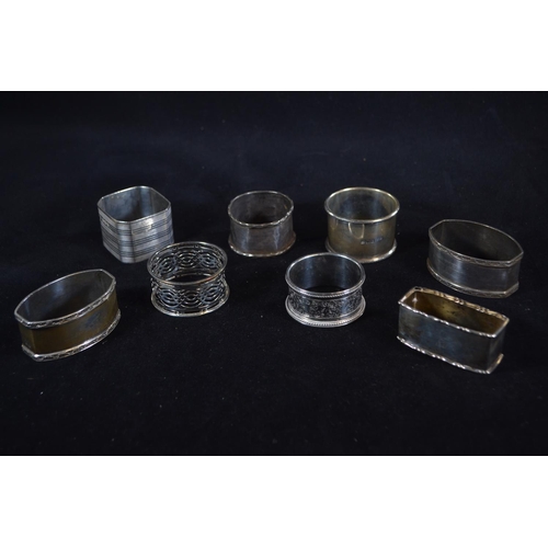 420 - Eight silver napkin rings, various makers and dates, including a pair and one 830 silver, gross weig... 