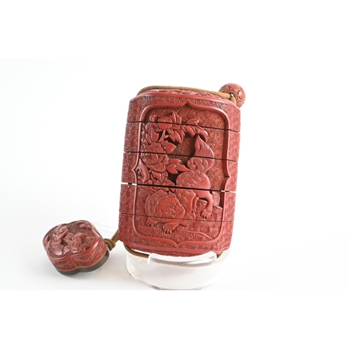 476 - Japanese cinnabar  four-case inro, carved with a dragon to one side and flowers to the other side, w... 