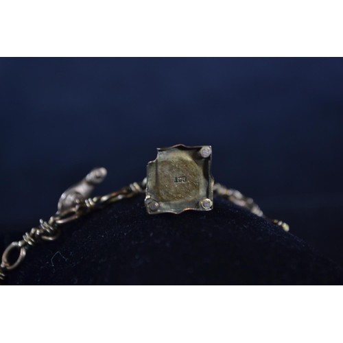 199 - 9ct gold charm bracelet with five charms including temple, lamp and others, gross weight 16 grams