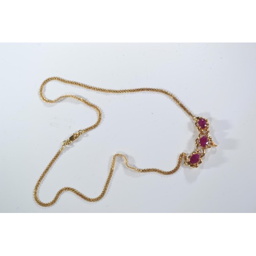 241 - 18ct gold necklace set with three rubies each measuring approx. 5mm x 4mm diameter and diamonds. Cir... 