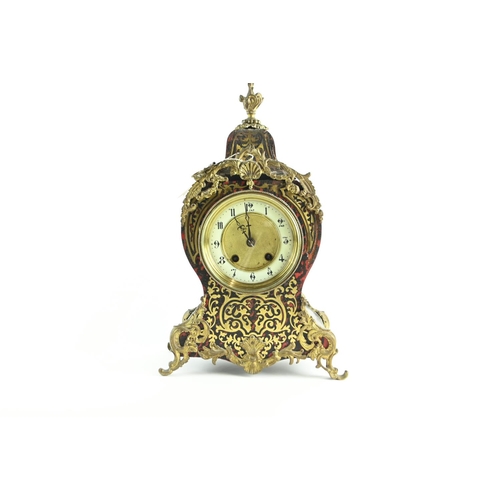 555 - Ornate French Brevete clock with enamelled dial, diameter 12 cms, with key.Ht 36 cms, widest point 2... 