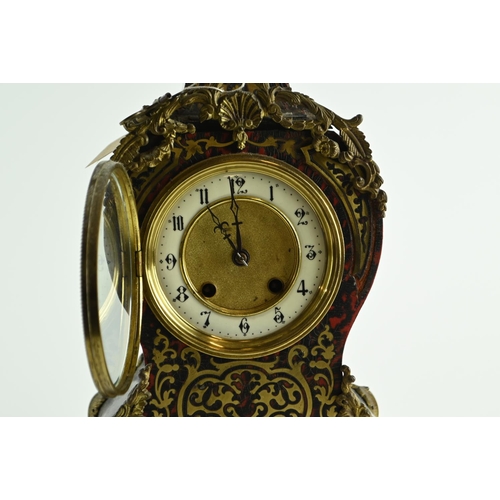 555 - Ornate French Brevete clock with enamelled dial, diameter 12 cms, with key.Ht 36 cms, widest point 2... 