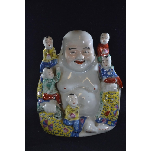 562 - A Chinese porcelain famille jaune figure of a seated Buddha, with five children, with oval seal mark... 