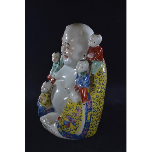 562 - A Chinese porcelain famille jaune figure of a seated Buddha, with five children, with oval seal mark... 