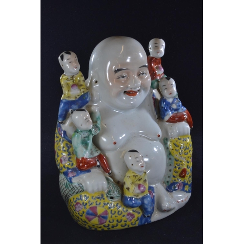 562 - A Chinese porcelain famille jaune figure of a seated Buddha, with five children, with oval seal mark... 