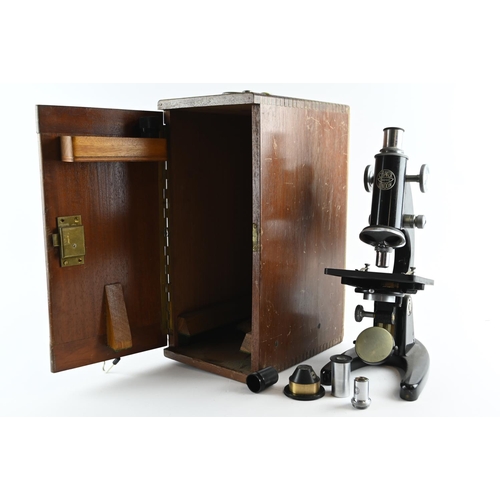 524 - A mid-20th century C. Baker London microscope, 34200, in wooden box with additional lenses and origi... 