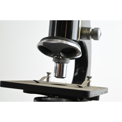 524 - A mid-20th century C. Baker London microscope, 34200, in wooden box with additional lenses and origi... 