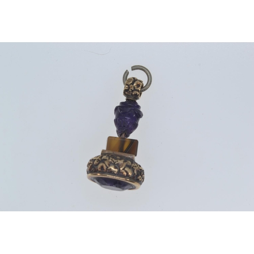 264 - Georgian yellow metal fob set with amethyst backed with agate and a carved amethyst bead. Gross weig... 