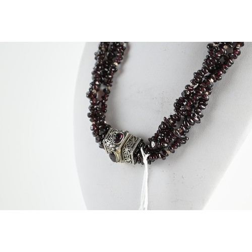 267 - Bohemian style 4 strand garnet bead necklace with white metal spacers and clasp. Approx 440mm circum... 