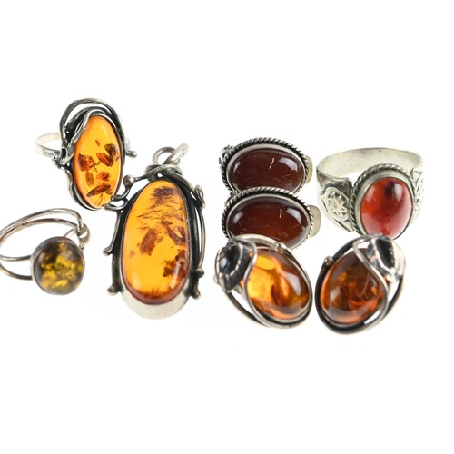 269 - Six pieces of Amber inc, two rings, pendant, two pairs of clip on earrings.