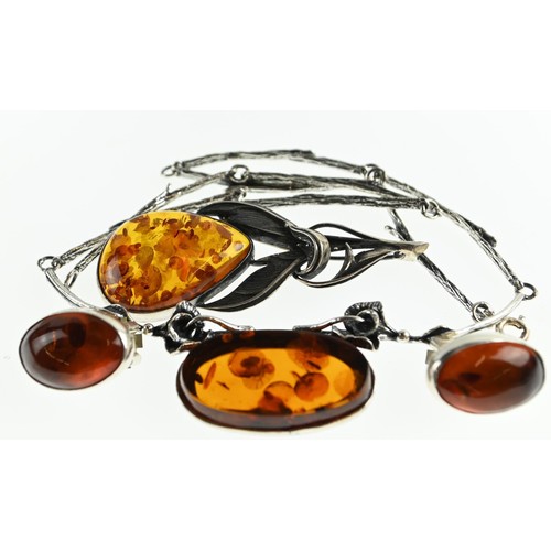 270 - Three pieces of amber set jewellery, including brooch, necklace and clip on earrings