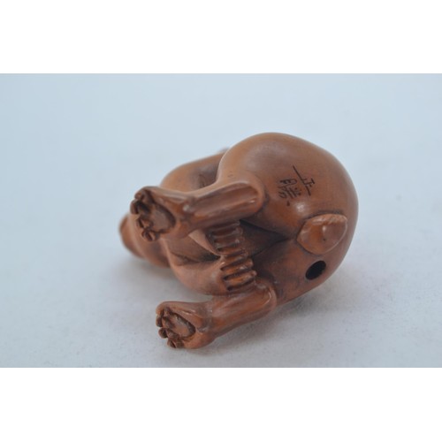 477 - Oriental carved boxwood pig, 7cm long. Together with a carved and signed hare netsuke, 5cm high.