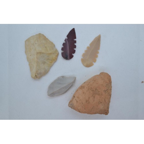 487 - Two Neolithic style stone tools and stone rattle, together with two flint arrow heads