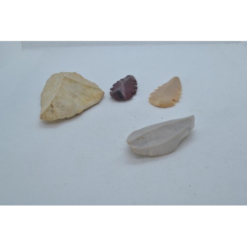 487 - Two Neolithic style stone tools and stone rattle, together with two flint arrow heads