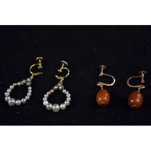 238 - Two pairs of screw back earrings. One pair, yellow metal with pearl and the other 9ct gold and amber... 