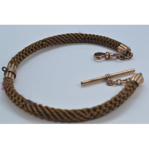 265 - Victorian mourning jewellery watch fob. Woven hair with yellow metal centre section and ends. Togeth... 