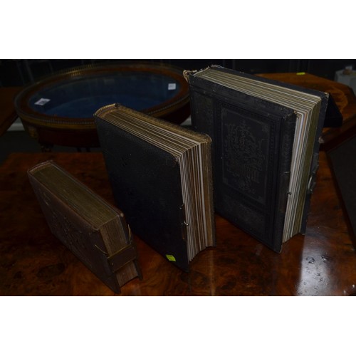 503 - Three late Victorian to Edwardian and possibly later photograph albums, including two leather bound ... 