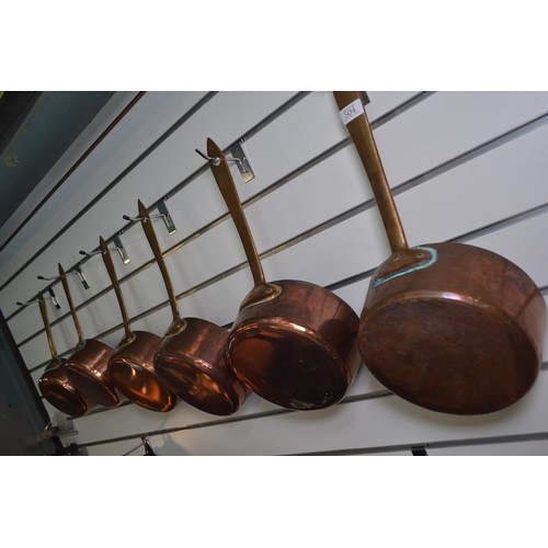 504 - Set of six copper saucepans, largest diameter of pan 23cm, smallest diameter of pan 18cm