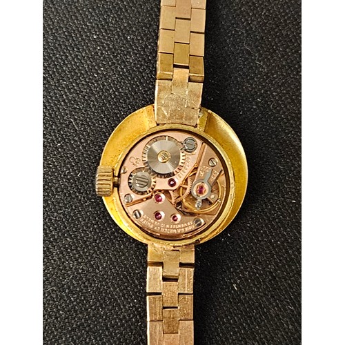 59 - Omega ladies 18ct gold watch on a 9ct strap  . Gross weight 24g. running