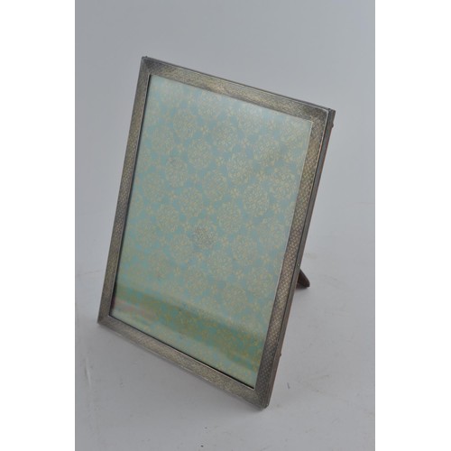 301A - Silver rectangular engine-turned photo frame, maker's mark rubbed, Birmingham 1928, 22.5 x 17.5cm