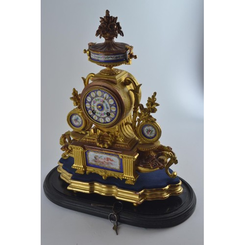 554 - Large ornate heavily gilded mantel clock with painted porcelain panels and face, marked PH Morey to ... 