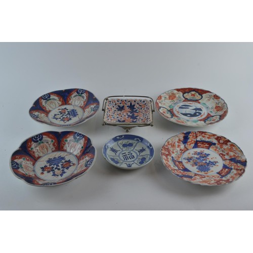 563 - Four Japanese Imari pattern plates, one with bats on rear of plate, and two others, one in a metal c... 