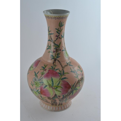 566 - A Chinese vase, bottle shaped with flared neck and decorated with nine peaches on an extensive peach... 