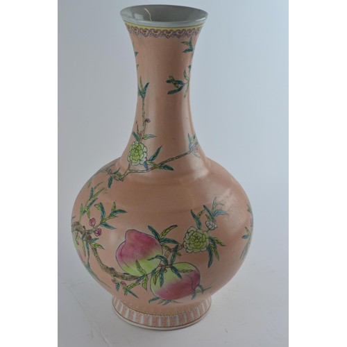 566 - A Chinese vase, bottle shaped with flared neck and decorated with nine peaches on an extensive peach... 