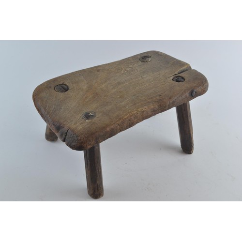 569 - Small rectangle four legged milking stool in hardwood, W30 D28 H16cm