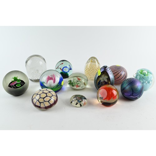 605A - A collection of  fourteen paperweights inc. iridescent, millefiori, captive bubble with some si... 