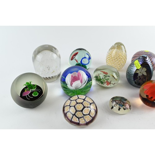 605A - A collection of  fourteen paperweights inc. iridescent, millefiori, captive bubble with some si... 