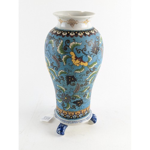 559 - A three footed Japanese porcelain cloisonné style vase decorated with floral motifs on a turquoise g... 