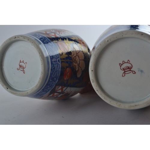 560 - Pair of Japanese Imari lidded vases with floral decoration, 33cm height to top of finial