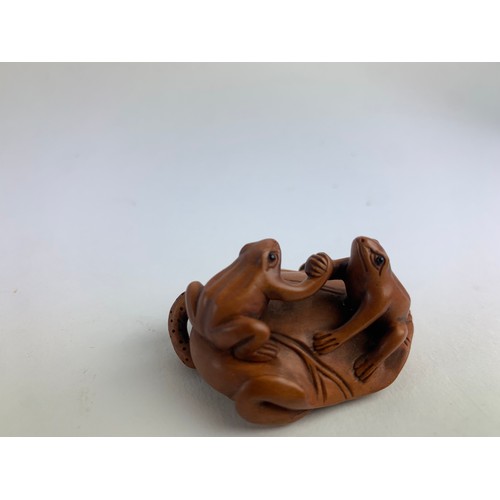 482A - Three hardwood carved frog netsukes, all with marks to base