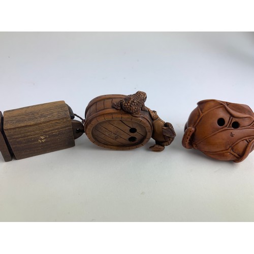 482A - Three hardwood carved frog netsukes, all with marks to base