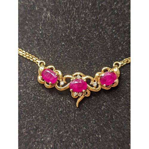 241 - 18ct gold necklace set with three rubies each measuring approx. 5mm x 4mm diameter and diamonds. Cir... 