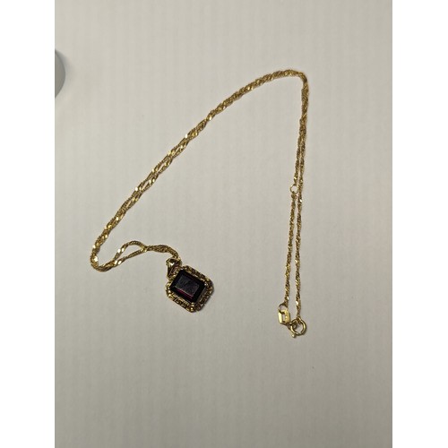 241A - 14ct gold chain with 14ct gold garnet set pendant. Chain circumference 470mm. Gross weight 3.24g