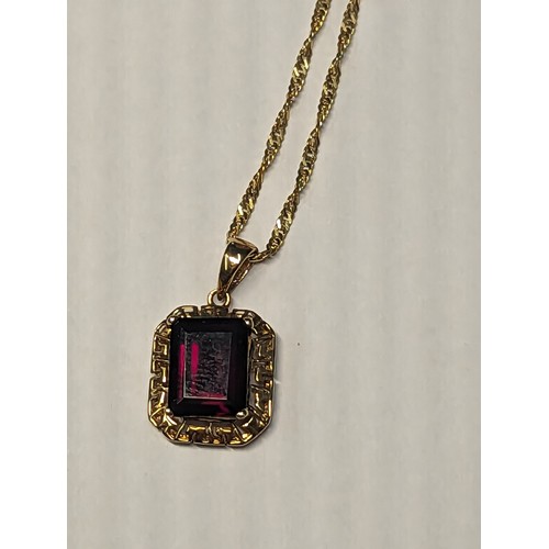 241A - 14ct gold chain with 14ct gold garnet set pendant. Chain circumference 470mm. Gross weight 3.24g