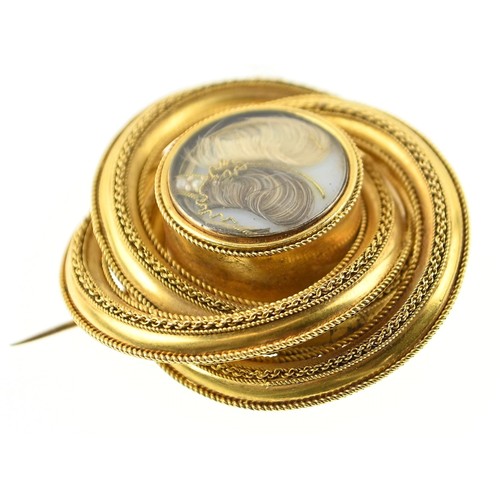 134 - Large yellow metal (testing positive of 18ct gold) mourning brooch in central glass, diameter 45mm. ... 