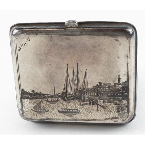 303 - Iraqi white metal and niello cigarette case, the cover decorated with a harbour scene, the base with... 