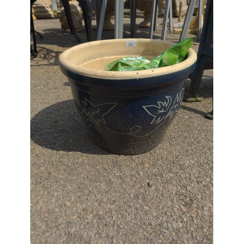 80 - Blue glazed pot + open bag of plant food 