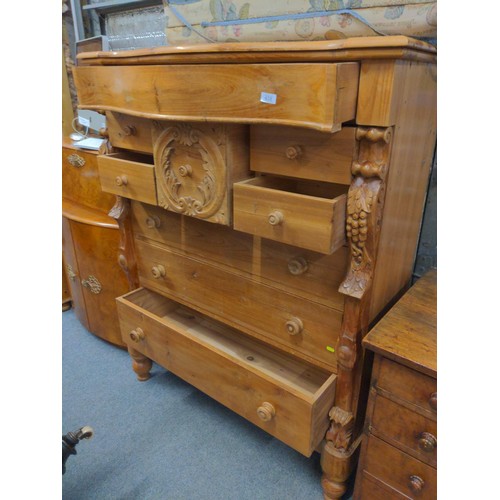 428 - Pine Scotch chest, comprised of 9 drawers, with central carved drawer frontage between twin grape ca... 