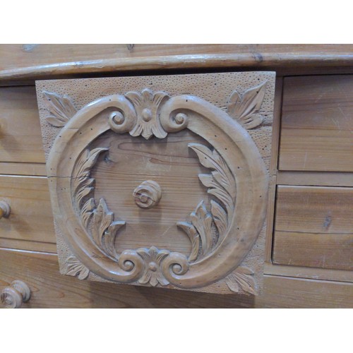 428 - Pine Scotch chest, comprised of 9 drawers, with central carved drawer frontage between twin grape ca... 