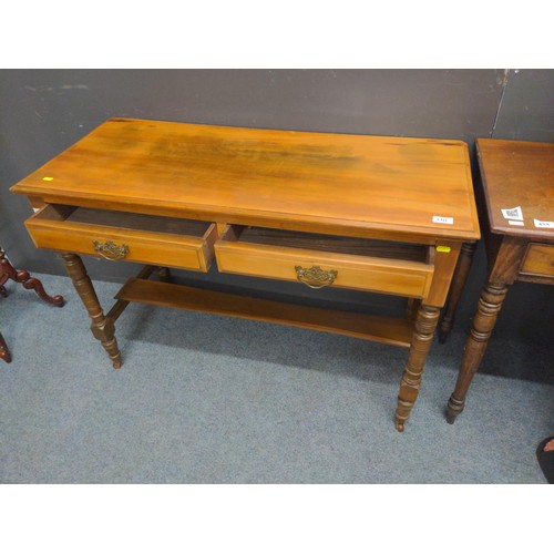 440 - Two drawer hardwood desk/ consul table. W107 D 47 H 73 cm with original castors.