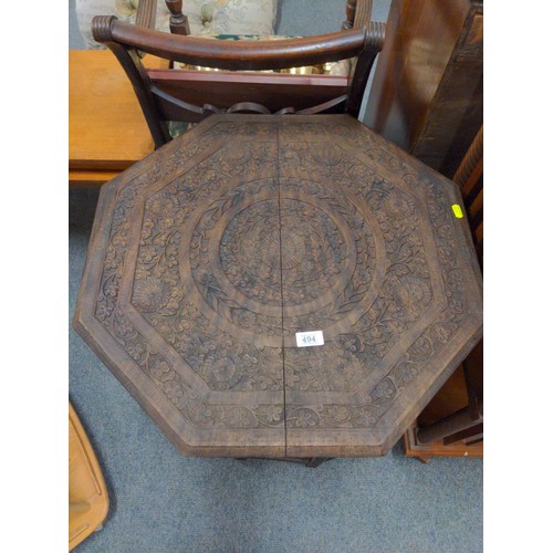 494 - Indian octagonal carved folding occasional table. D61cm H65cm