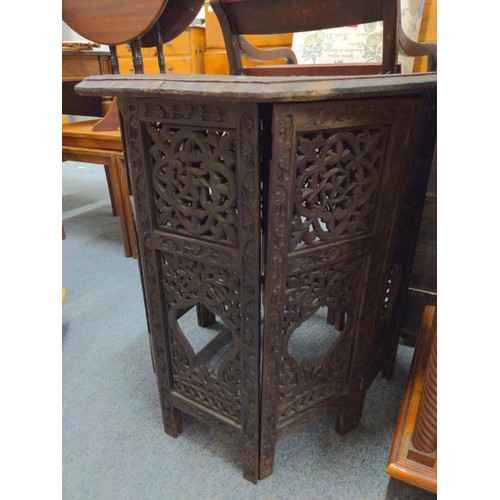 494 - Indian octagonal carved folding occasional table. D61cm H65cm